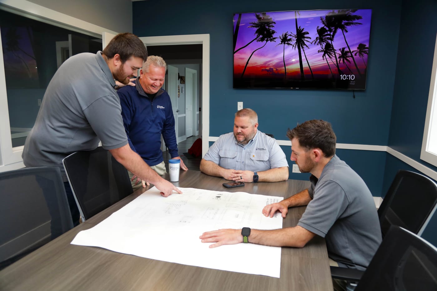 Shorite Controls and Process Integration staff reviewing a panel drawing